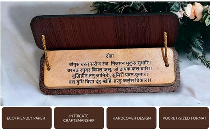 Wooden plaque with engraved text on a white surface with flowers